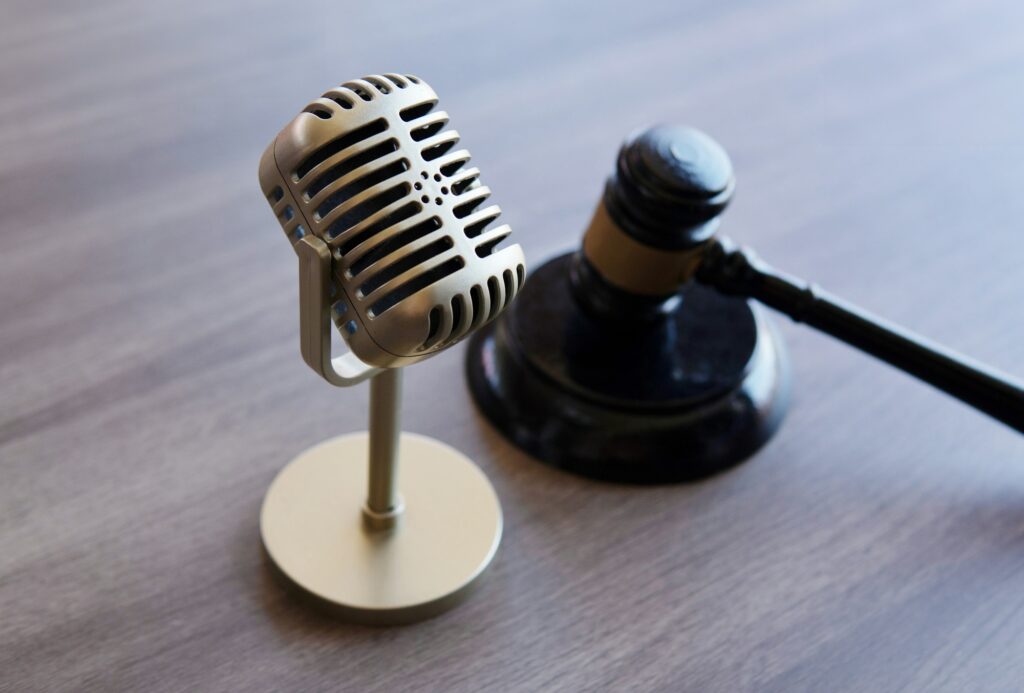 Closeup image of microphone and judge gavel.