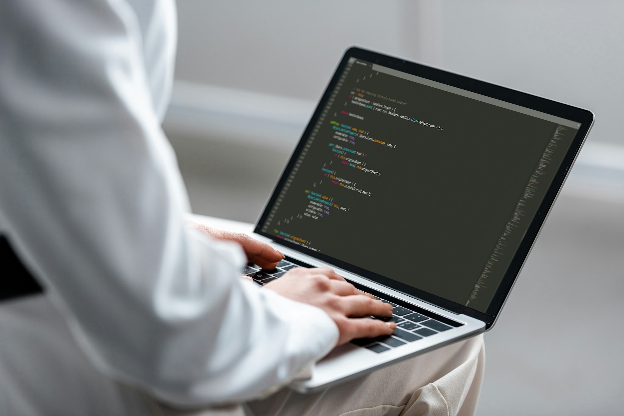 cropped view of woman using laptop with microsoft windows on screen