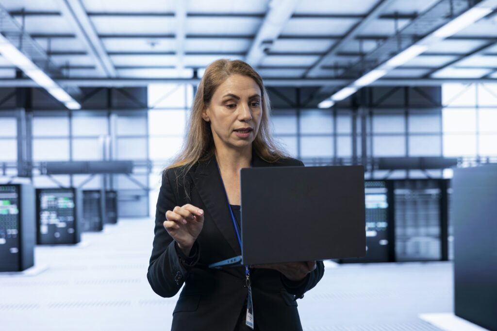 Data center IT expert doing hardware upgrades using notebook