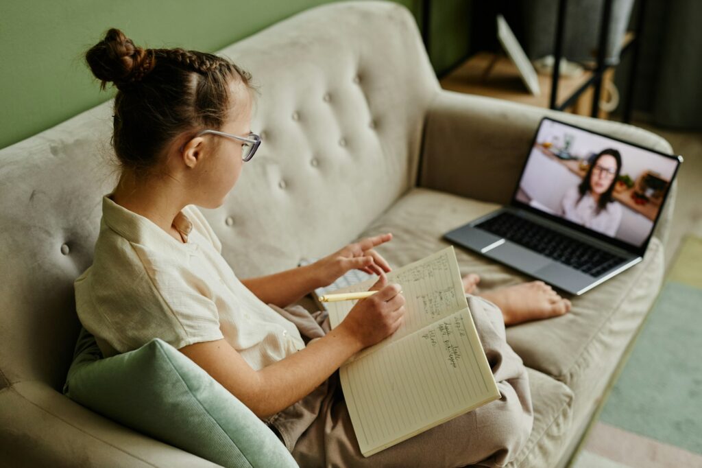 Girl with Down Syndrome Watching Online Lesson