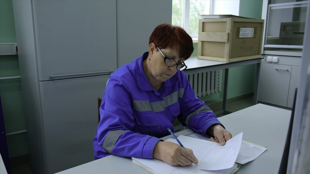 Hospital attendants. Clip. Working women filling out journals and describing tests.