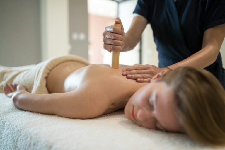 Masseur treating patient with therapeutic massage