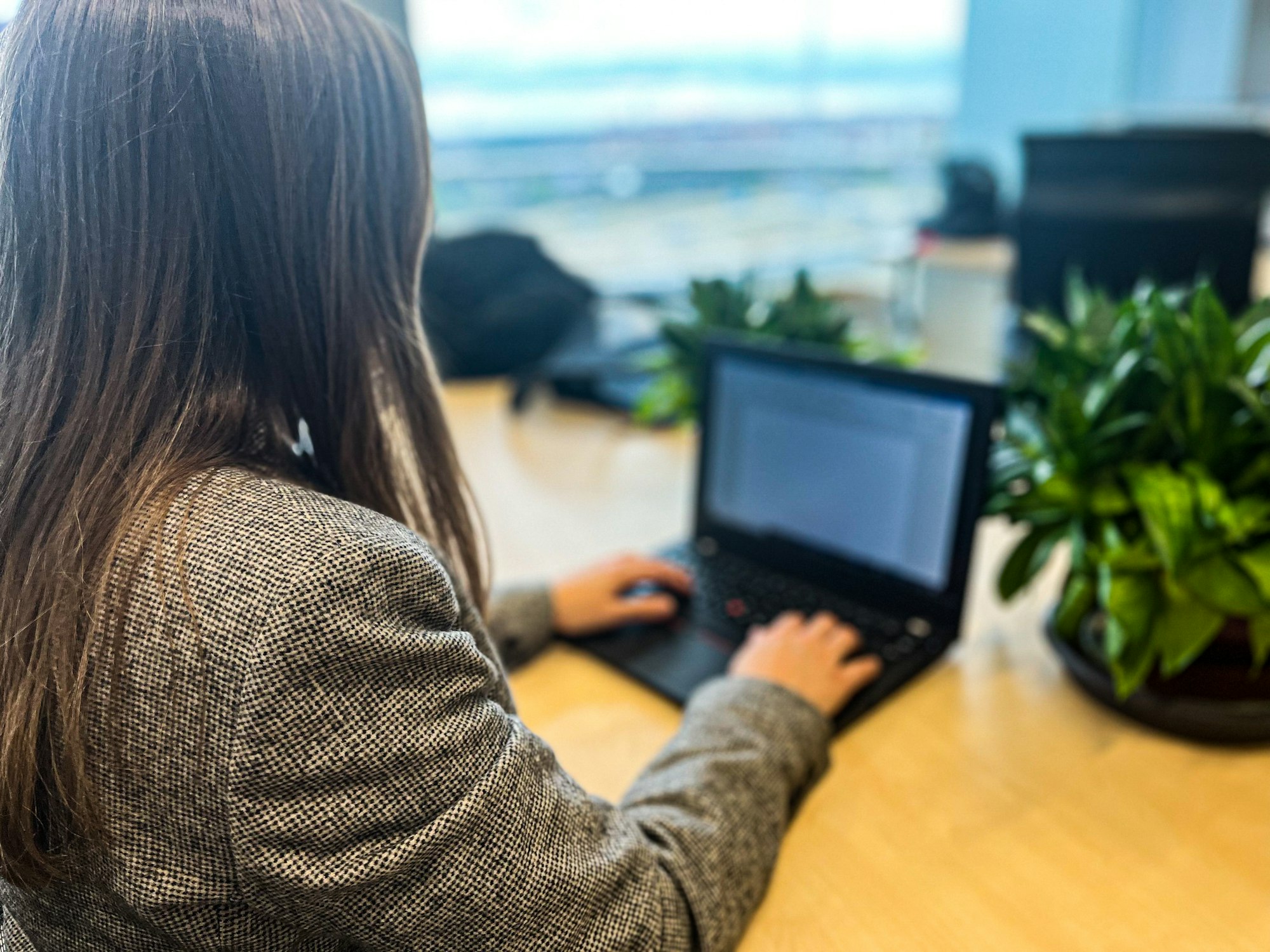 Millennial woman working with her laptop in a modern office, business woman, workplace, technology