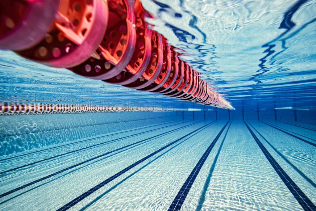 Olympic Swimming pool under water background.