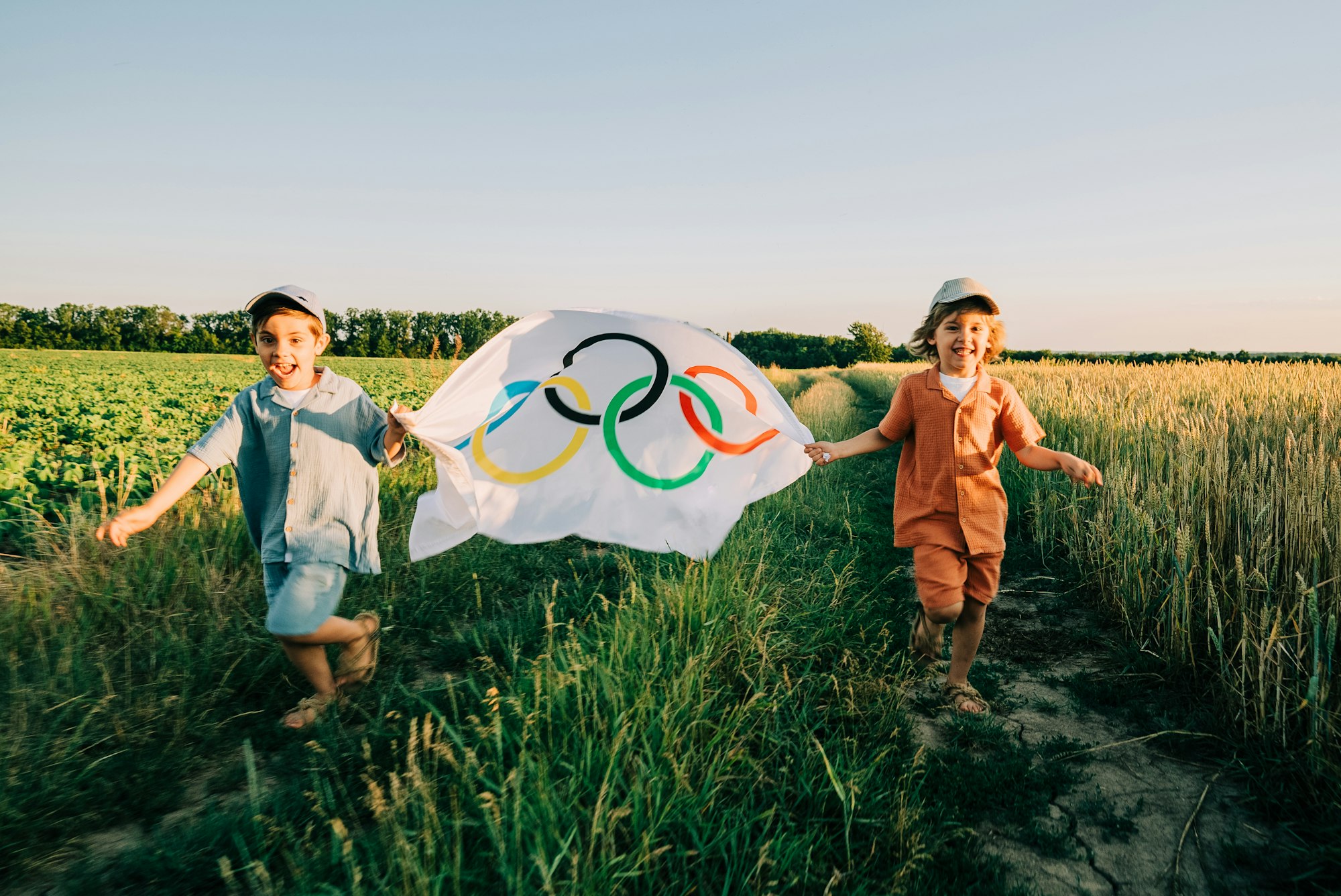 paris, france 18 may 2024: little boys, sport fan kids running with olympics