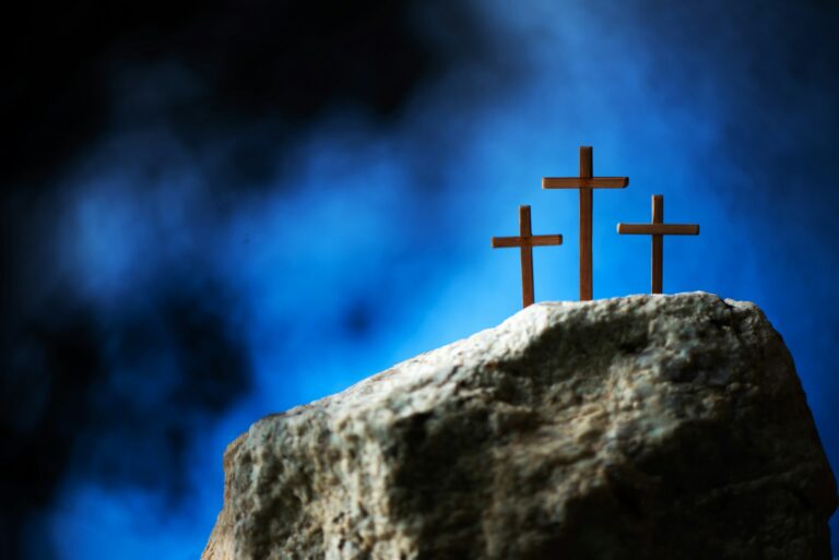 Silhouette of three crosses on Calvary hill, blue background. Crucifixion, resurrection of Jesus