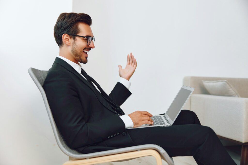 Sitting man workplace technology business happy chair winner excited laptop job businessman office