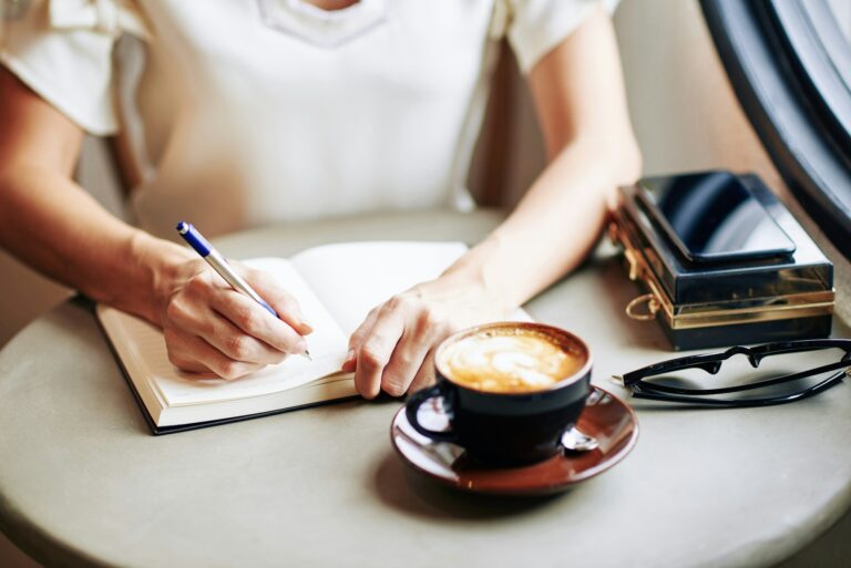 Woman filling gratitude journal