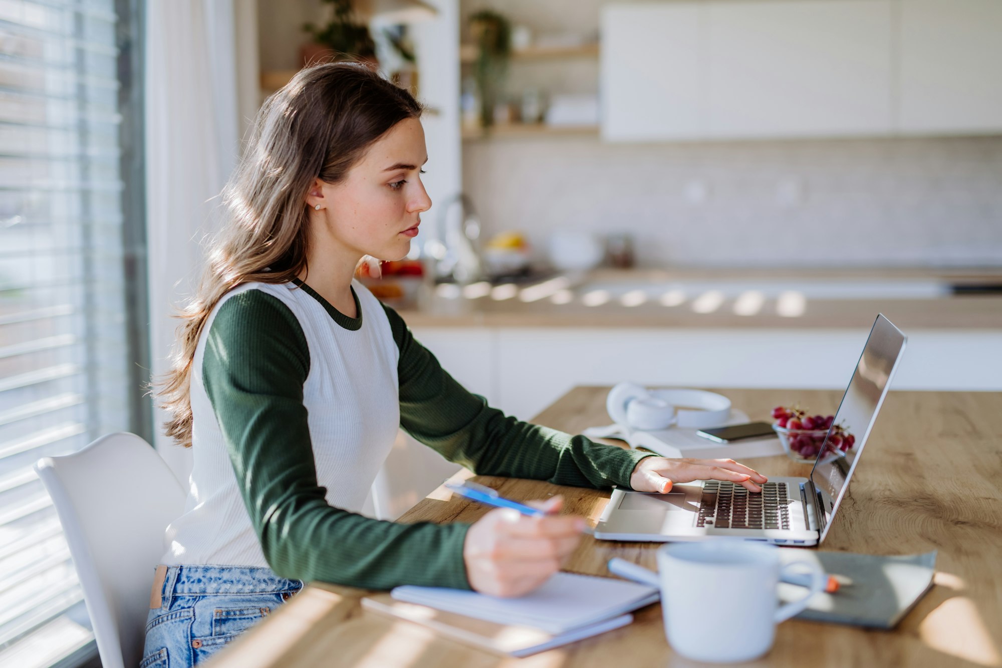 Young woman having distance education in her apartment.