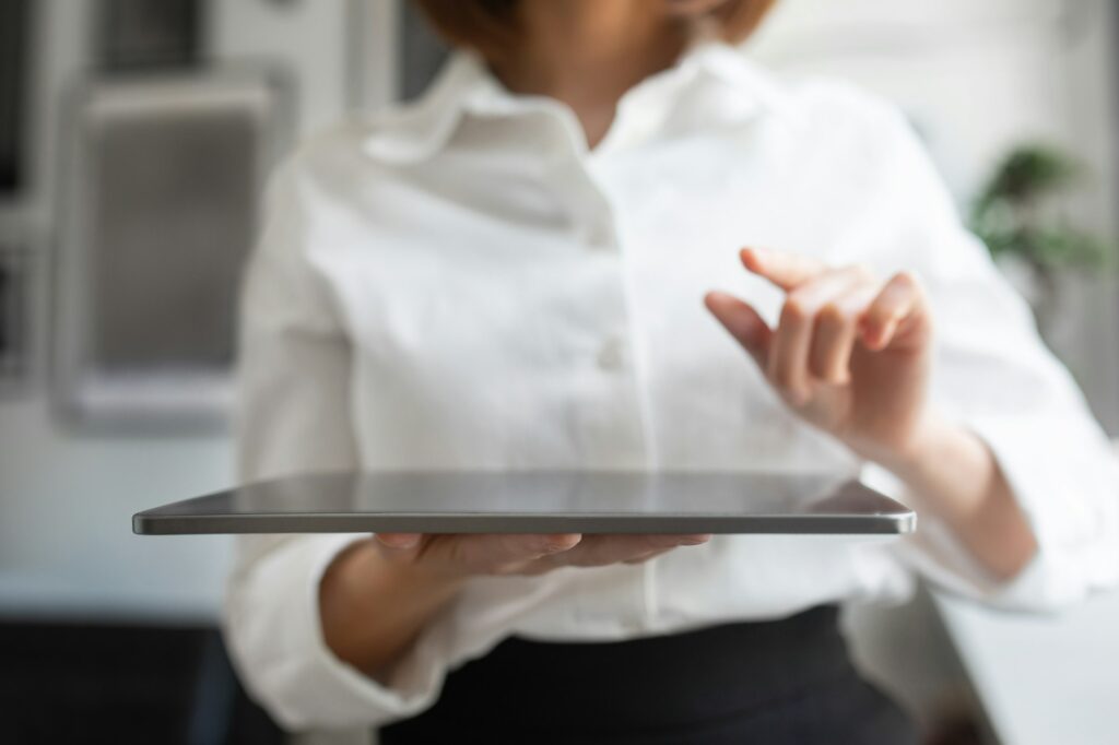 Artificial intelligence system. Businesswoman holding digital tablet and pointing finger or pressing