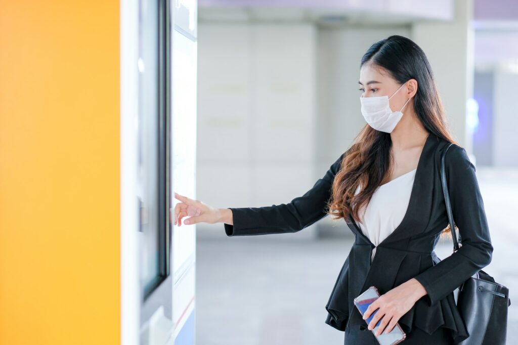 Beautiful business woman with hygiene mask point to sky train or transportation map