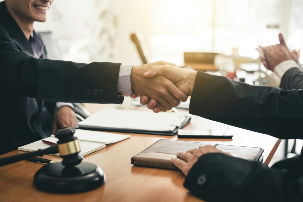 Businessman shaking hands discussing a contract agreement.