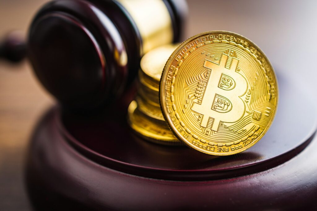 Cryptocurrency. Bitcoin virtual money. Golden coins and judge gavel.