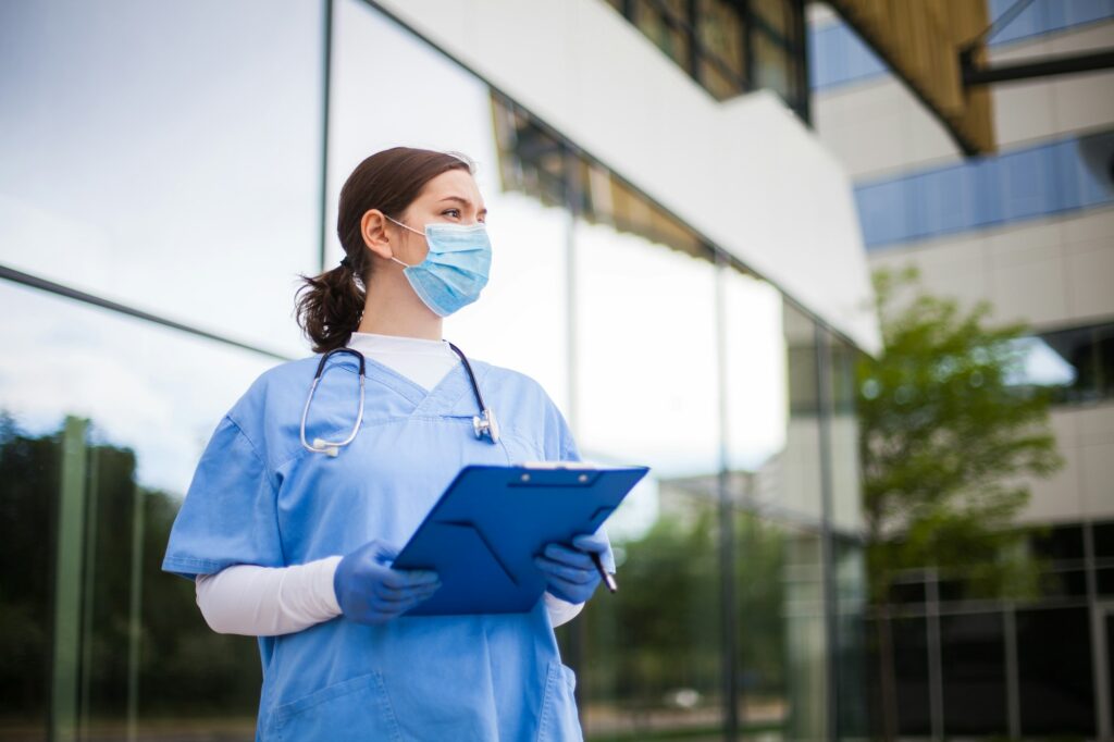 Doctor in front of hospital