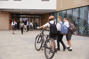 Group Of High School Students Wearing Uniform Arriving At School