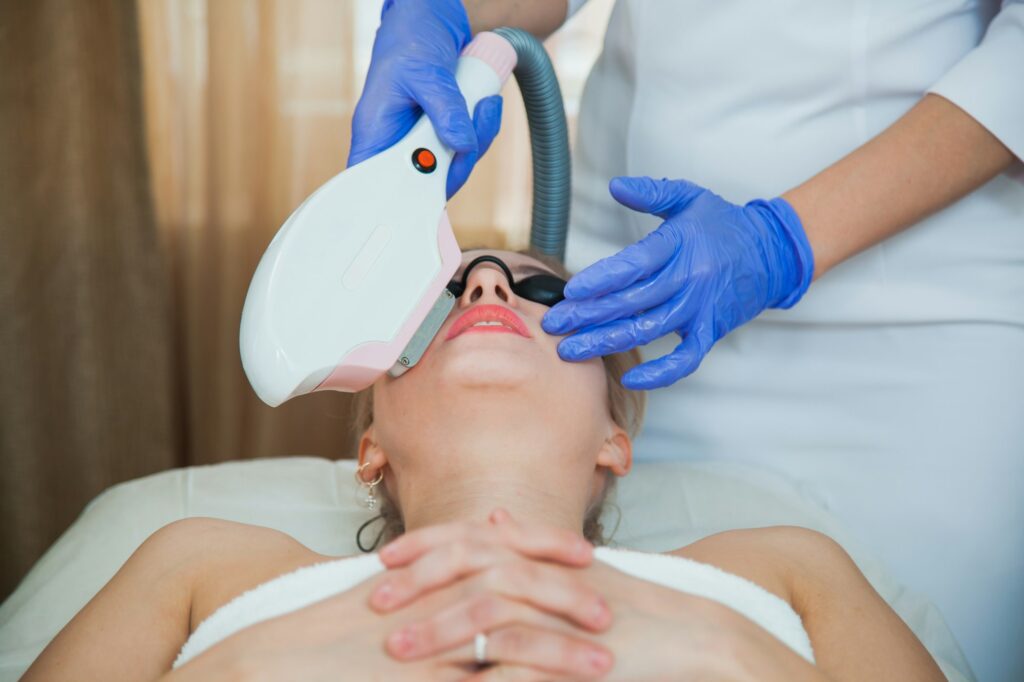 Laser face skin therapy in cosmetology beauty cabinet.