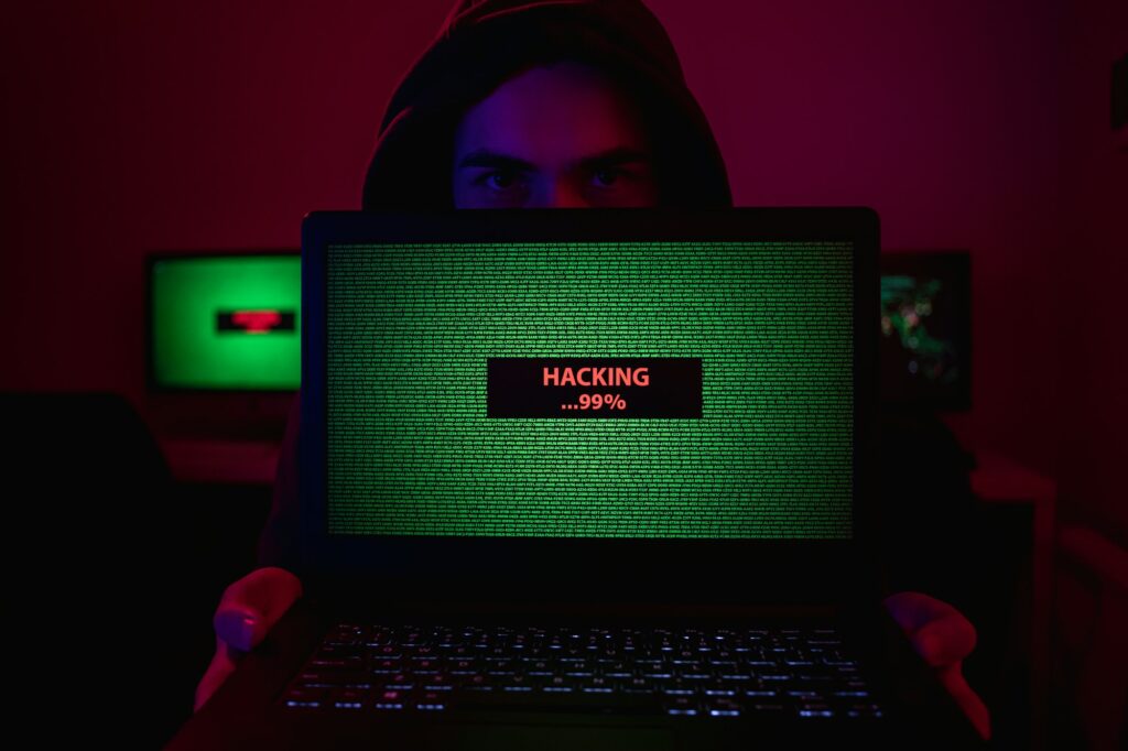 Man showing laptop with hacking process