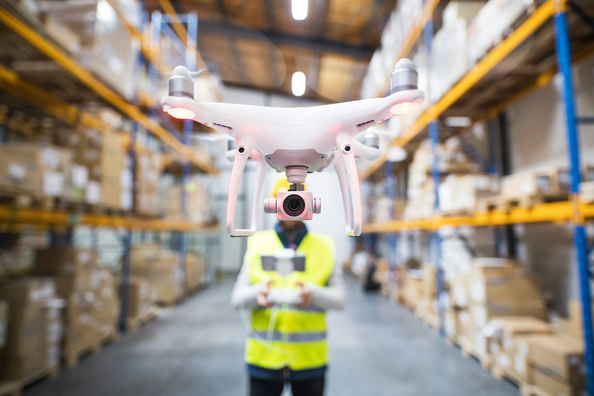 Man with drone in a warehouse.