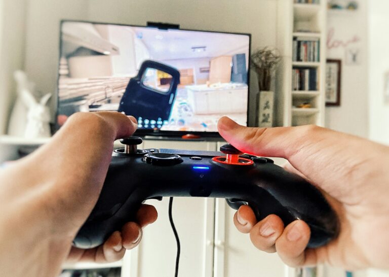 Playing videogame PlayStation holding teen hands on controller