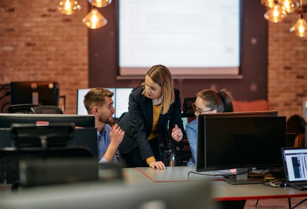 Strategic Business Meeting: Group of Professionals Collaborating in Office Using Computers