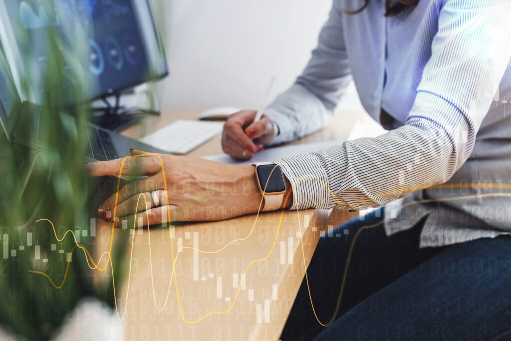 Unrecognizable woman working in finance, sitting by her desk working