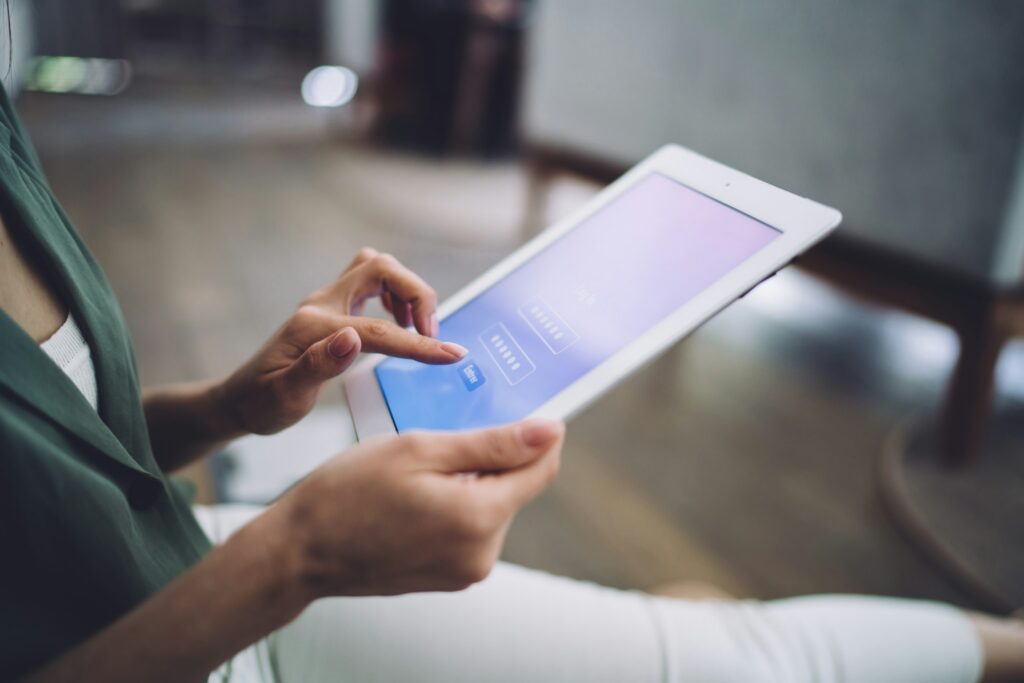 Woman entering password in tablet