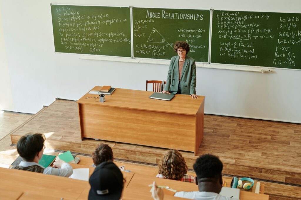 Young confident teacher of algebra explaining angle relationships to students