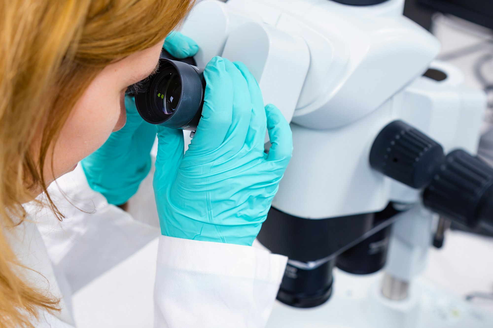 A scientist is utilizing a microscope, embodying the concepts of medical healthcare technology.