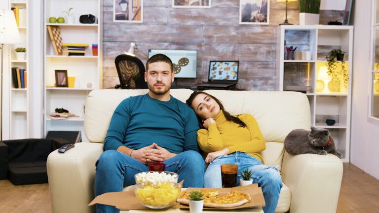 Bearded man changing tv channels with hand gestures