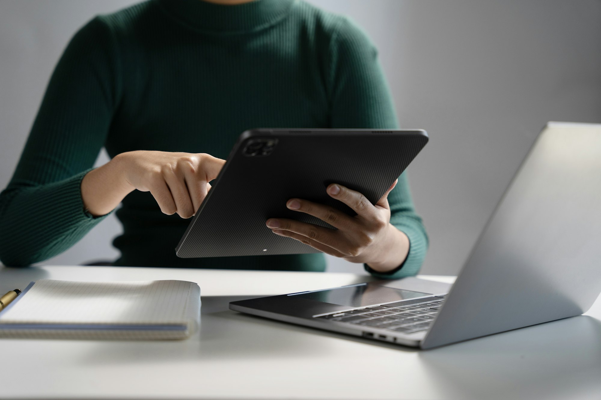 Businesswoman working on tablet and laptop computer, searching working in office.