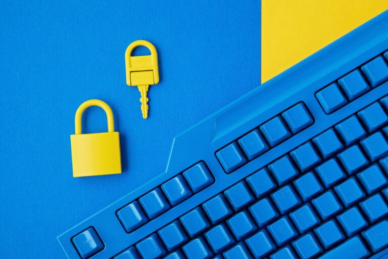 Cyber data and information security idea. Yellow padlock and key and blue keyboard. Computer