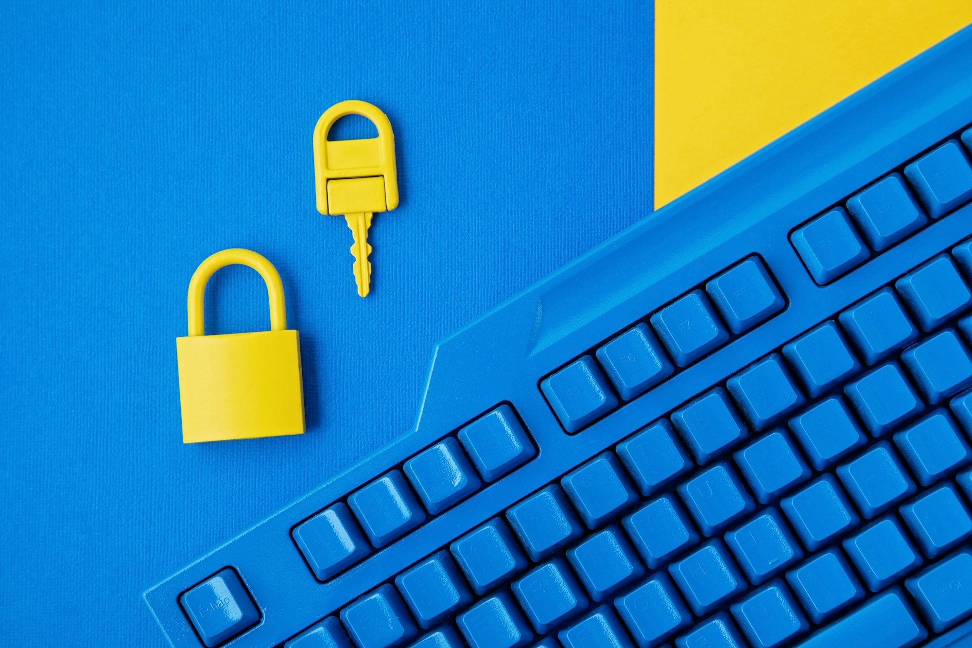 Cyber data and information security idea. Yellow padlock and key and blue keyboard. Computer