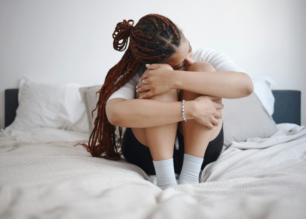 Depression, anxiety and sad woman on bed with a mental healthy problem. Suicide, depressed or insom