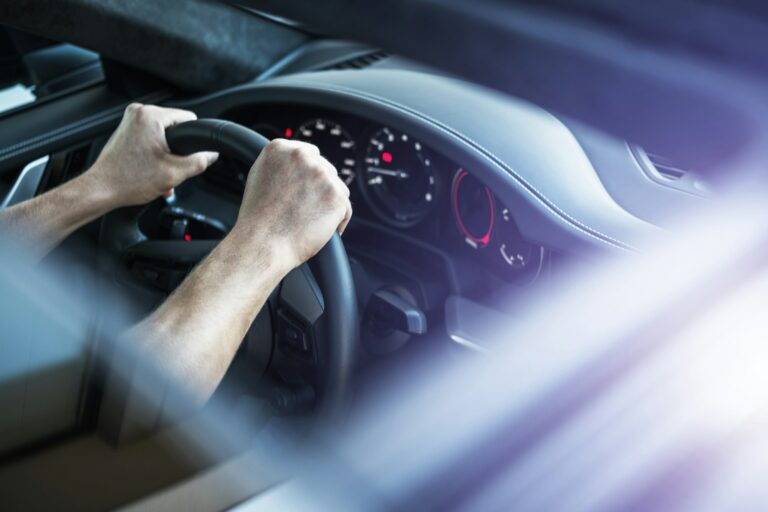 Driver Behind Supercar Steering Wheel