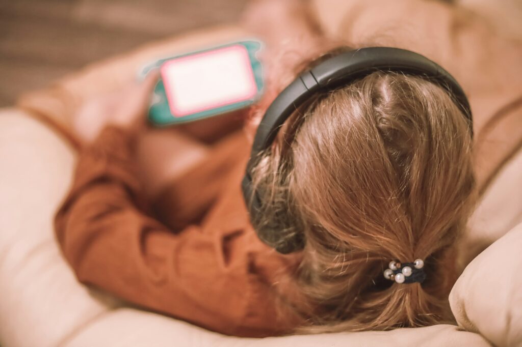 little girl listening to music on the phone, surfing the internet, playing games, making a videocall