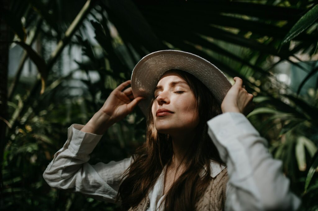 Portrait of young woman in botanical garden.