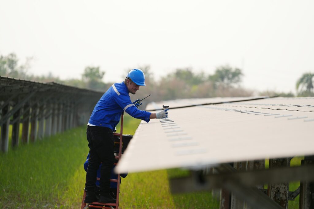 Solar power plant, Electrician working on checking and maintenance equipment