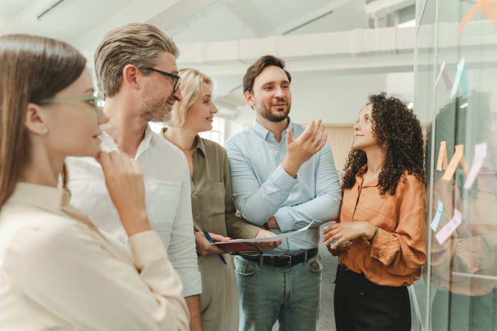 Successful businesspeople using sticky notes, agile methodology for productivity working together