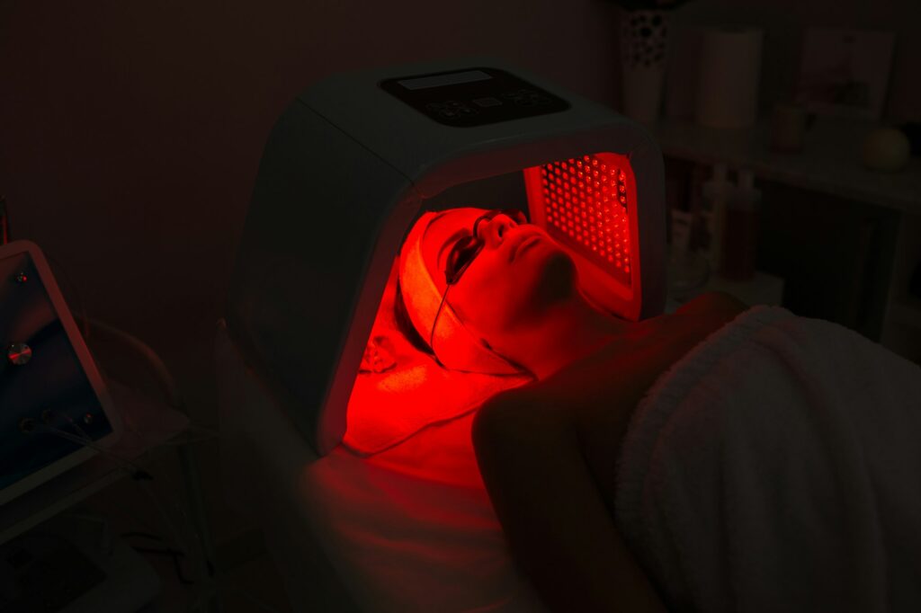 Woman having Ultraviolet LED light facial treatment at beauty salon