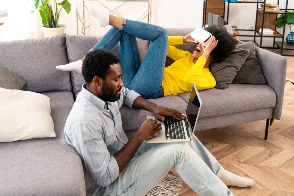 Afro couple using computer laptop at home