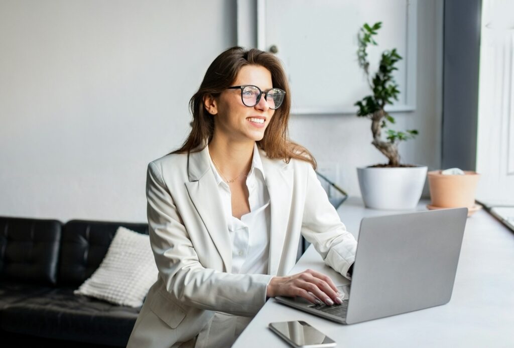 Happy Young European Businesswoman Using Laptop Computer Working Online Indoor