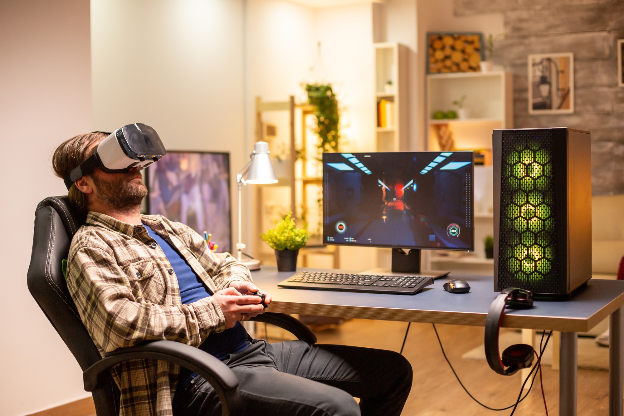 Professional gamer man using VR headset to play on powerful PC