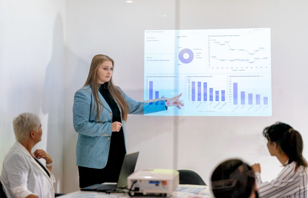 Shot of a mature businesswoman sitting and training her team in the office.