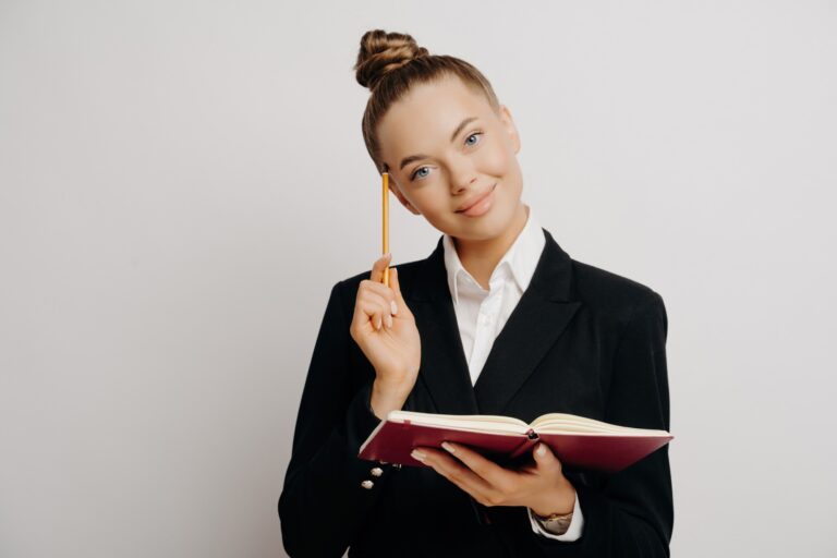 Smart female worker generates business ideas with red notebook