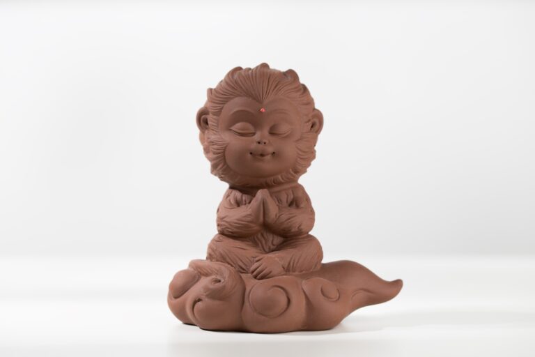 The monkey king doll sits on a cloud and meditates.