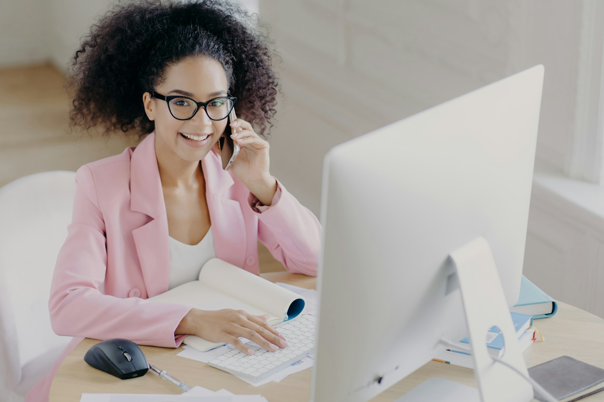 woman in jacket working at her compute, immersed in professional problem solving.