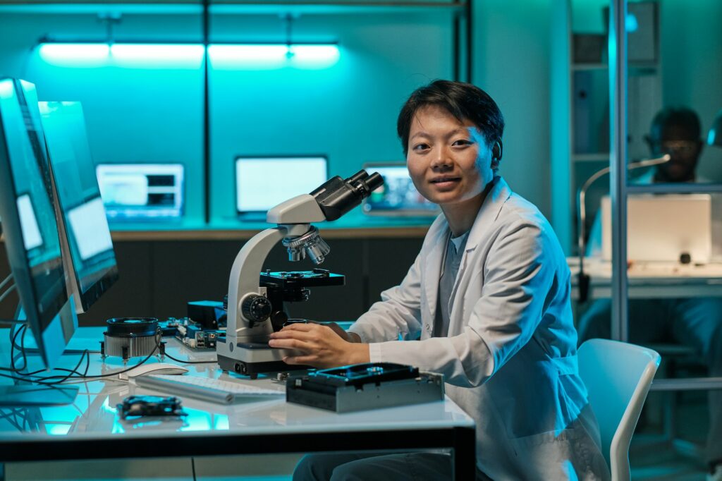 Young successful chinese female researcher with microscope