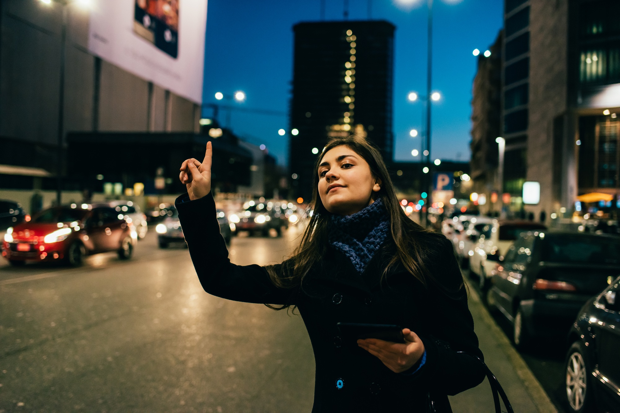 Young woman hailing taxi