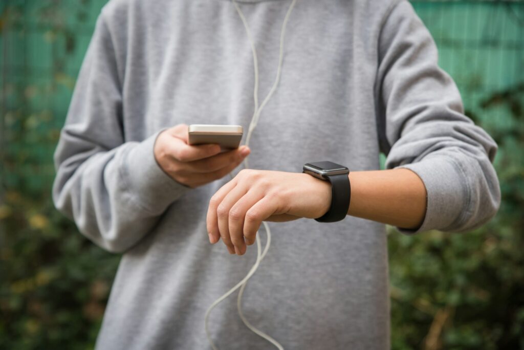 Young woman using wearable tech during fitness workout