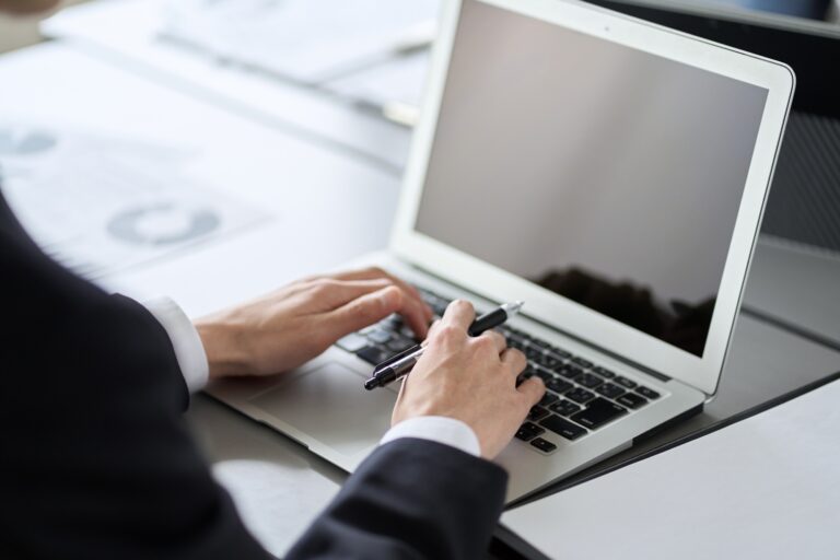 A business person who operates a laptop for desk work